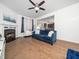 Bright living room with fireplace, hardwood floors, and comfortable blue sofa at 329 Chamberlain Dr, Clayton, NC 27527