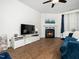 Living room with fireplace, modern furniture, hardwood floors and ceiling fan at 329 Chamberlain Dr, Clayton, NC 27527