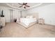 Spacious main bedroom with tray ceiling, neutral carpet, and light-filled windows at 329 Chamberlain Dr, Clayton, NC 27527