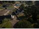 Scenic aerial perspective of a gray home with a wooden deck, fenced yard, and mature trees at 35 Fairway Ct, Dunn, NC 28334