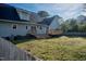 Lawn with fenced in yard, tiered deck and barbeque at 35 Fairway Ct, Dunn, NC 28334