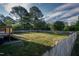 Large green backyard fully enclosed by a wooden fence and a deck in the corner at 35 Fairway Ct, Dunn, NC 28334