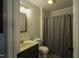 Bathroom with a shower curtain and a dark wood vanity under a cream sink at 35 Fairway Ct, Dunn, NC 28334