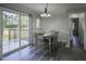 Dining room featuring laminate flooring, slider to the backyard deck, and decorative lighting at 35 Fairway Ct, Dunn, NC 28334