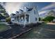 Charming home featuring a covered porch with rocking chairs and manicured landscaping at 35 Fairway Ct, Dunn, NC 28334