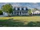 Charming two-story home featuring a welcoming front porch with swing and rocking chairs at 35 Fairway Ct, Dunn, NC 28334