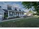 Attractive home featuring a cozy front porch, well-manicured lawn, and colorful flowerbeds at 35 Fairway Ct, Dunn, NC 28334
