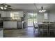 Modern kitchen/dining area with stainless steel appliances, white cabinets, and views to backyard at 35 Fairway Ct, Dunn, NC 28334