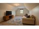 Cozy living room features natural light, TV, and comfortable seating area at 35 Fairway Ct, Dunn, NC 28334
