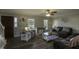 Inviting living room featuring laminate flooring, a ceiling fan, and plenty of natural light at 35 Fairway Ct, Dunn, NC 28334