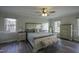 Serene main bedroom featuring a neutral palette, laminate floors, and abundant natural light at 35 Fairway Ct, Dunn, NC 28334