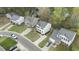 An aerial view shows a well-placed two-story home with green spaces, driveways, and surrounding neighborhood at 3717 Phillips W Way, Durham, NC 27713