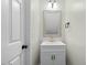 Bathroom showcasing a modern vanity, sink, and stylish fixtures next to a white door at 3717 Phillips W Way, Durham, NC 27713