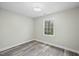 Bright bedroom featuring a window with view to the outside and hardwood floors at 3717 Phillips W Way, Durham, NC 27713