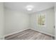 Bright bedroom features hardwood flooring and a window with a view to the outside at 3717 Phillips W Way, Durham, NC 27713