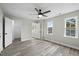 A bright bedroom features two windows, stylish flooring and a closet at 3717 Phillips W Way, Durham, NC 27713