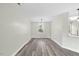 Neutral dining space with wood-look floors, a stylish chandelier, and a window providing natural light at 3717 Phillips W Way, Durham, NC 27713
