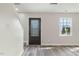 Bright entryway features wood-look flooring, a decorative front door with glass, and a window with natural light at 3717 Phillips W Way, Durham, NC 27713