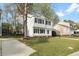 Inviting two-story home showcasing a green lawn, timeless black shutters, and a convenient paved driveway at 3717 Phillips W Way, Durham, NC 27713