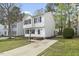 Attractive two-story home featuring a well-kept lawn, contrasting black shutters and a paved driveway at 3717 Phillips W Way, Durham, NC 27713
