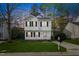 Charming two-story home with a well-manicured lawn, classic black shutters and a paved driveway at 3717 Phillips W Way, Durham, NC 27713