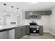 Well-equipped kitchen with stainless steel appliances, tile backsplash, and pendant lighting at 3717 Phillips W Way, Durham, NC 27713