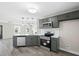 Modern kitchen design with stainless steel appliances, gray cabinetry, and stylish lighting at 3717 Phillips W Way, Durham, NC 27713