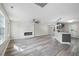 Open-concept living area boasting wood-look floors, modern fireplace, ceiling fan, and plenty of natural light at 3717 Phillips W Way, Durham, NC 27713
