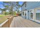 Expansive wooden back deck, blue siding, and manicured lawn enhance this inviting outdoor living space at 3808 Johnson Pond Rd, Apex, NC 27539