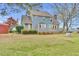 Spacious backyard with a well-maintained lawn, complemented by a blue home with a deck and mature trees at 3808 Johnson Pond Rd, Apex, NC 27539