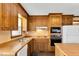 Cozy kitchen area featuring wood countertops, appliances, and double sink under a window at 3808 Johnson Pond Rd, Apex, NC 27539