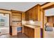 Well-organized kitchen area with cabinets, built-in desk, and seamless access to adjacent living spaces at 3808 Johnson Pond Rd, Apex, NC 27539