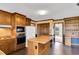 Functional kitchen with wood cabinets, a central island, and appliances included for convenience at 3808 Johnson Pond Rd, Apex, NC 27539