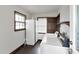 Well-lit laundry room with white appliances, wood trim, and a window bringing in natural light at 3808 Johnson Pond Rd, Apex, NC 27539