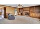 Cozy living room with a brick fireplace, built-in shelves, and a ceiling fan at 3808 Johnson Pond Rd, Apex, NC 27539