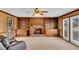 Cozy living room with a brick fireplace, built-in shelves, and a ceiling fan at 3808 Johnson Pond Rd, Apex, NC 27539