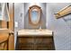 Traditional powder room featuring a wood vanity, soft countertop, and blue wallpaper at 3808 Johnson Pond Rd, Apex, NC 27539