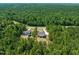 Aerial view of home nestled in a lush, green forest, offering privacy and serenity at 390 Pilot Ridge Rd, Zebulon, NC 27597