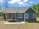 Rear exterior of home showcasing the screened porch, siding, and concrete patio at 390 Pilot Ridge Rd, Zebulon, NC 27597