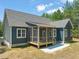 Back exterior of home featuring screened porch and concrete patio at 390 Pilot Ridge Rd, Zebulon, NC 27597