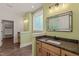 Well-lit bathroom featuring dual sinks with wood cabinets and a decorative mirror, offering a functional and stylish space at 390 Pilot Ridge Rd, Zebulon, NC 27597