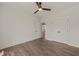 Bedroom features wood-look floors, ceiling fan, and double doors, creating a cozy retreat at 390 Pilot Ridge Rd, Zebulon, NC 27597