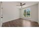 Bright bedroom with ceiling fan, a window overlooking the greenery, and durable wood-look flooring at 390 Pilot Ridge Rd, Zebulon, NC 27597