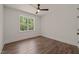 Well-lit bedroom with a ceiling fan, a window view, and beautiful wood-look flooring at 390 Pilot Ridge Rd, Zebulon, NC 27597