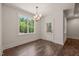 Bright dining area with a stylish chandelier, a large window offering natural light, and a door to the outside at 390 Pilot Ridge Rd, Zebulon, NC 27597