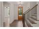 Bright entryway with hardwood floors, wooden staircase, and a clear view of the front door at 390 Pilot Ridge Rd, Zebulon, NC 27597