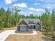 Charming exterior showcasing landscaping, stylish color palette, and a well-manicured lawn at 390 Pilot Ridge Rd, Zebulon, NC 27597