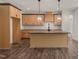 Beautiful kitchen with wooden cabinets, a center island, and modern light fixtures at 390 Pilot Ridge Rd, Zebulon, NC 27597