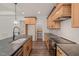 Bright kitchen with a large center island, stone countertops, and wooden cabinetry at 390 Pilot Ridge Rd, Zebulon, NC 27597
