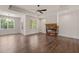 Bright living room with a stone fireplace, large windows, and an open layout at 390 Pilot Ridge Rd, Zebulon, NC 27597